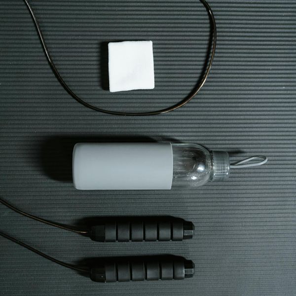 Minimalist setup with a yoga mat, water bottle, and a towel.